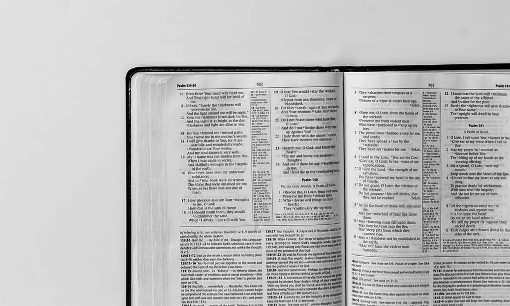 Open Bible showing Psalm 139 on white background.