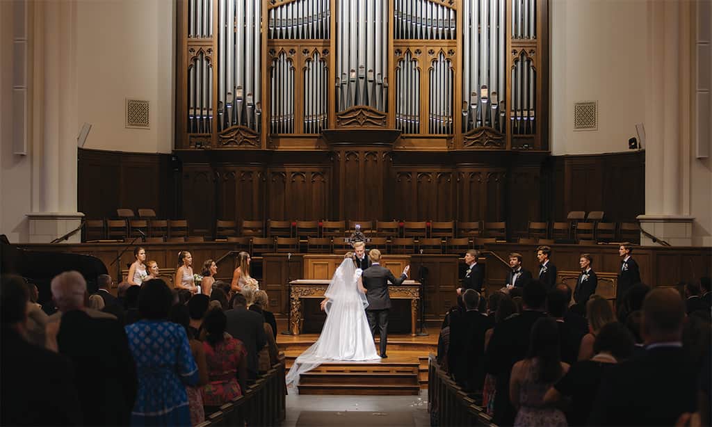 Bride and groom standing at the altar during a ceremony at a church wedding venue in Dallas, TX.