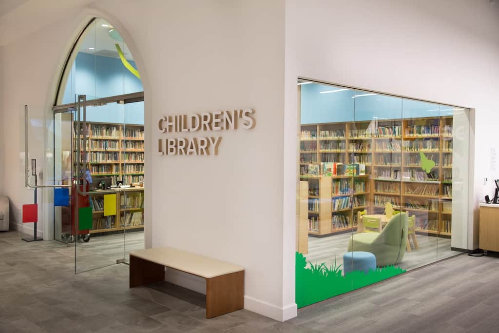 Children’s library at Park Cities Presbyterian Church with bookshelves, reading chairs, and glass entry doors.