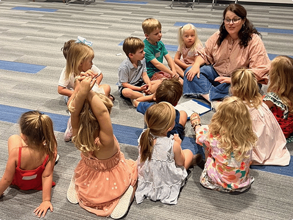 Teacher leading children’s circle time at church.