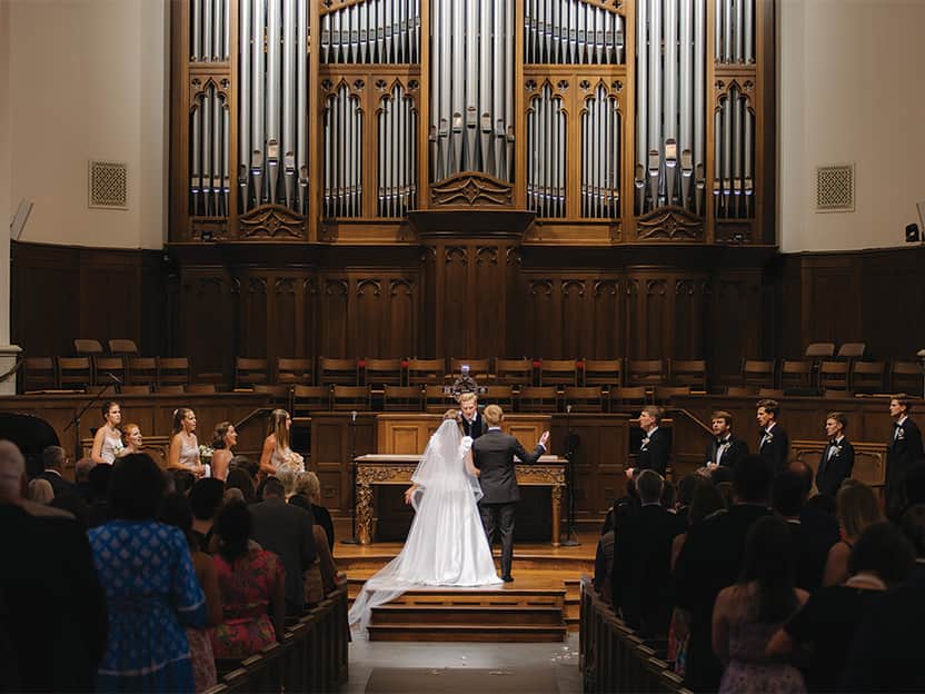 Bride and groom standing at the altar during a ceremony at a church wedding venue in Dallas, TX.